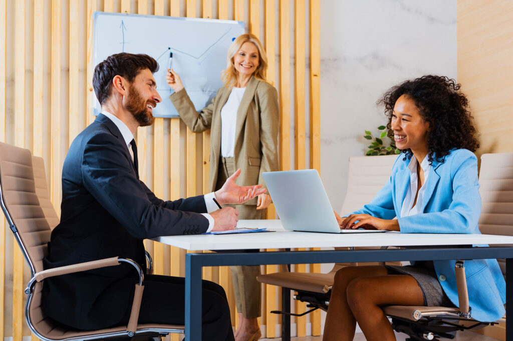Business owner meeting with a funding advisor or professional team in a modern office.