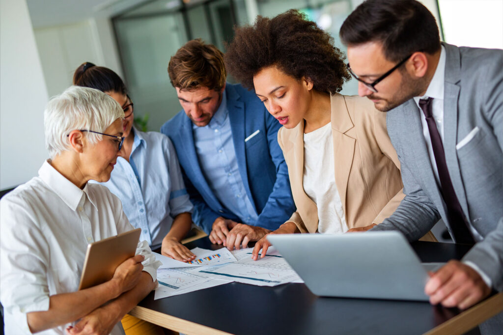 Business owner working with an advisor or team while reviewing financial information.