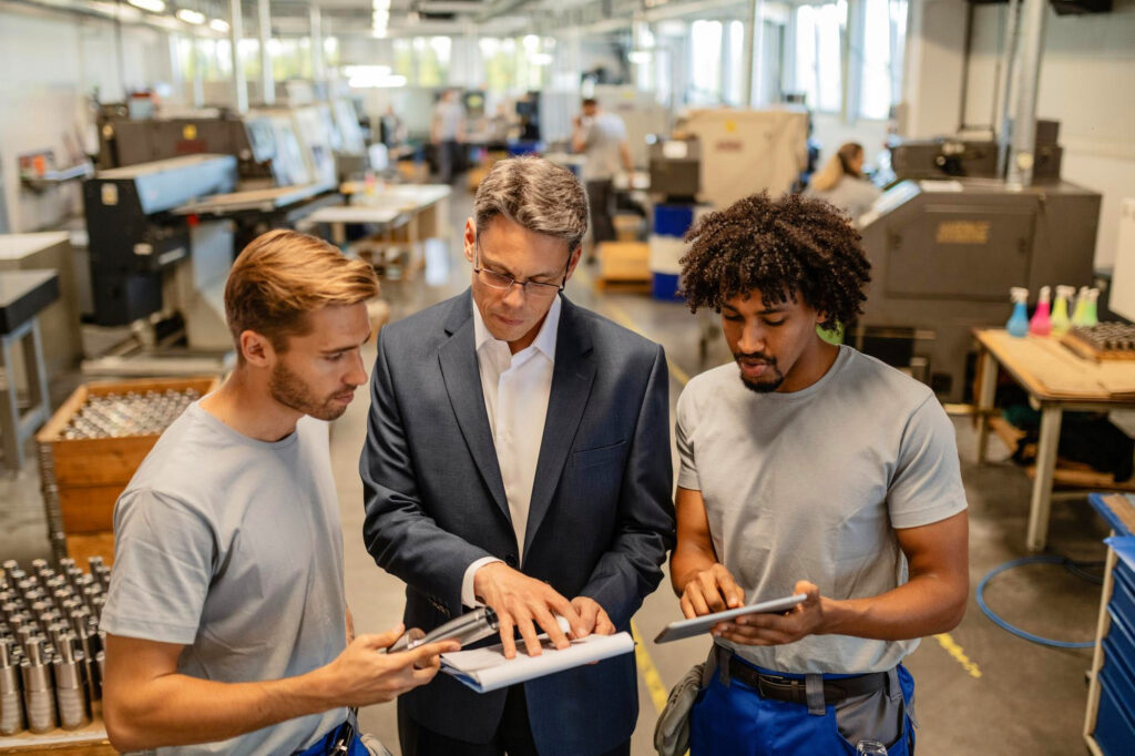 Manufacturing business owner discussing production plans with a team member or funding advisor.
