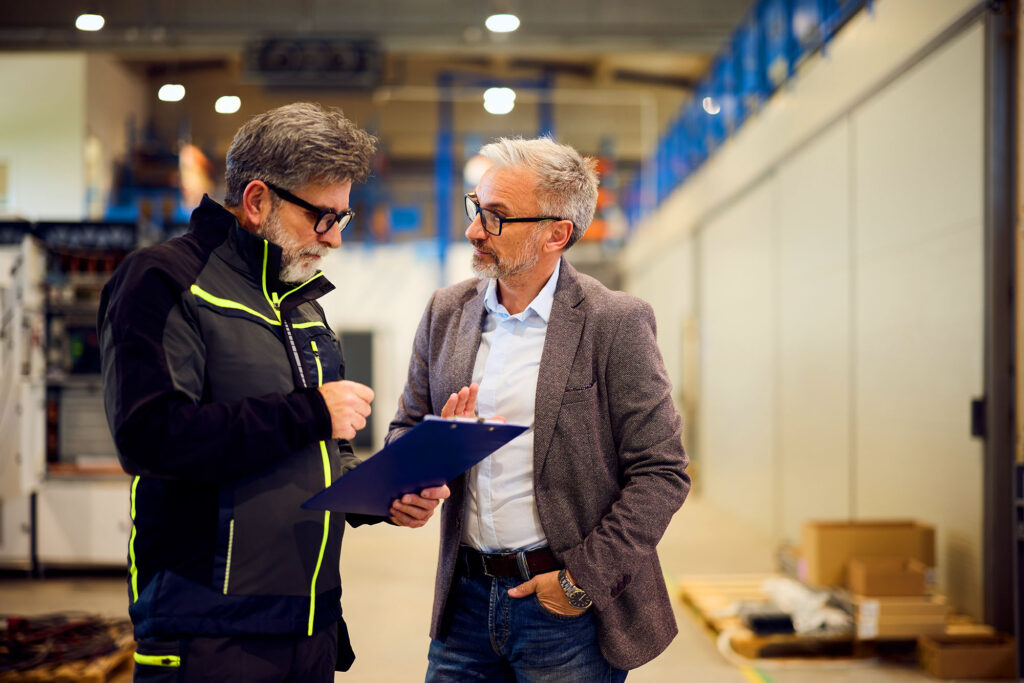 Transportation business owner and logistics manager reviewing fleet performance